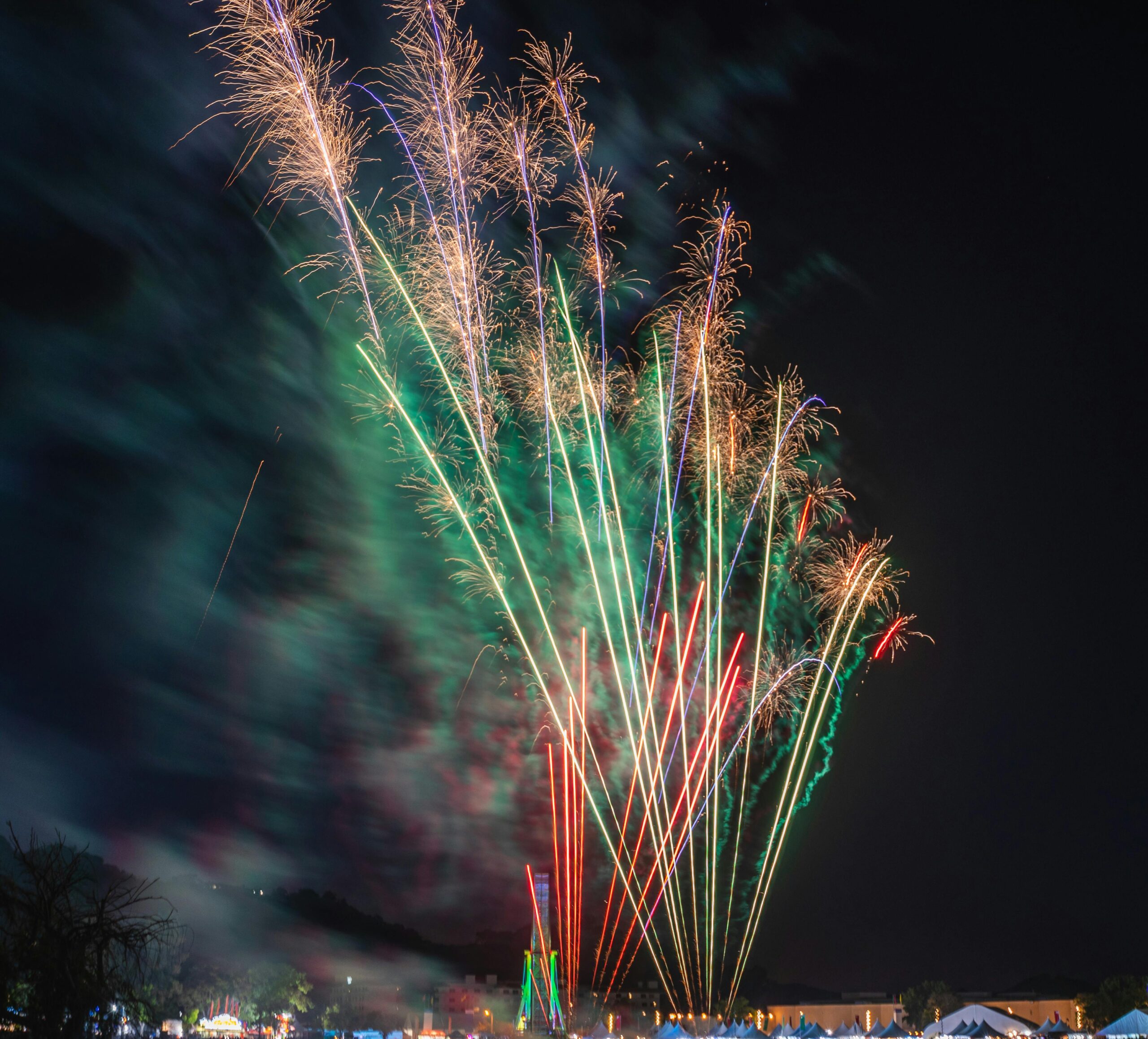 Colorful fireworks illuminating the night sky during a festive celebration.